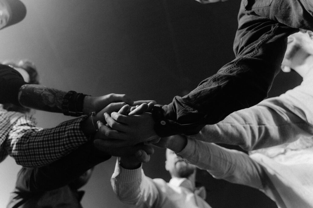 pexels-photo-5710947-5710947 A group of diverse hands united in a gesture of teamwork and collaboration.